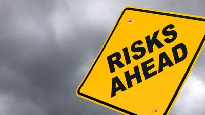 Yellow sign that reads "Risks Ahead"