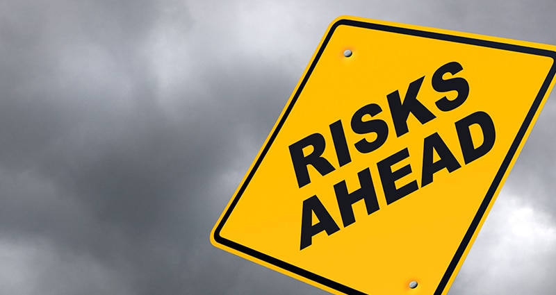 Yellow sign that reads "Risks Ahead"