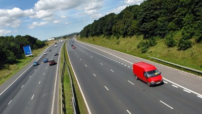 Red van driving down highway