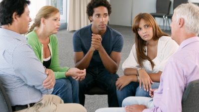 Group of five people intimately talking