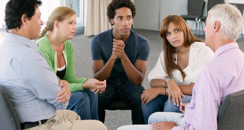 Group of five people intimately talking