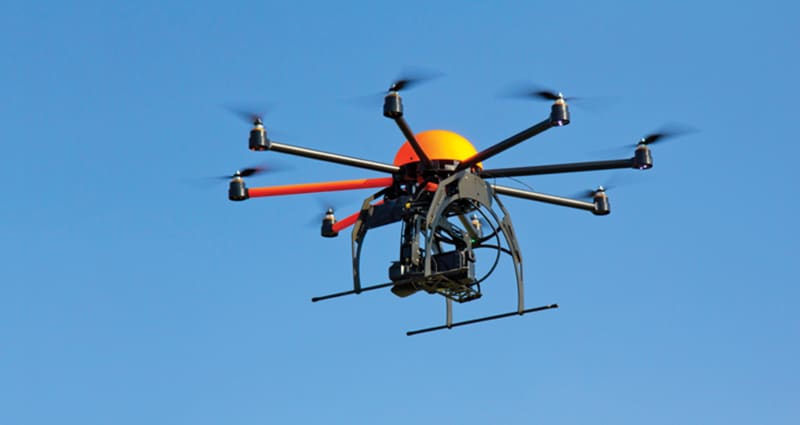 Large drone flying in cloudless sky