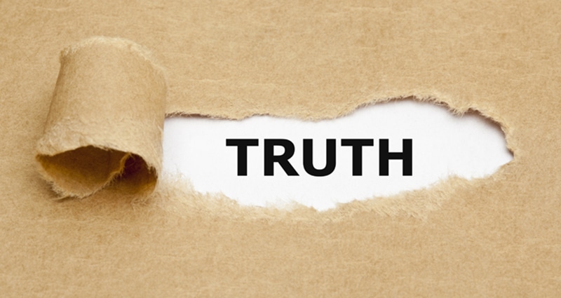 Paper ripped back revealing the word "truth"