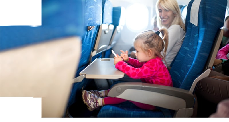 Mom and child smiling in coach seats