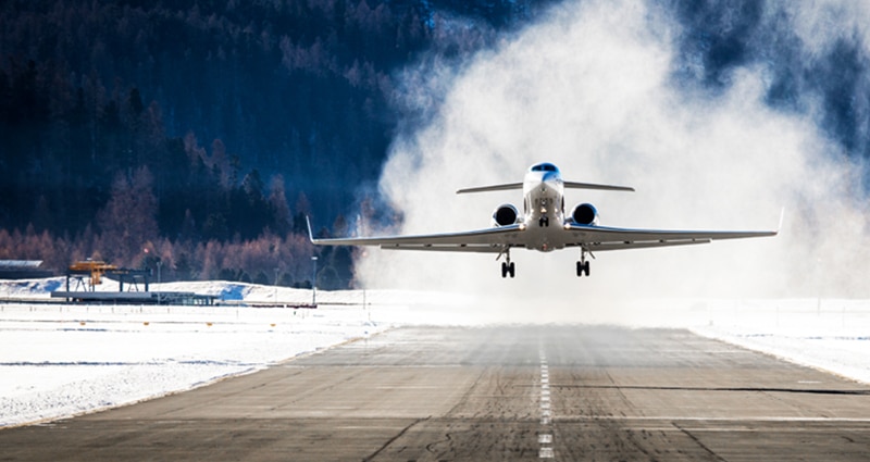 Jet plane landing on snowy runway