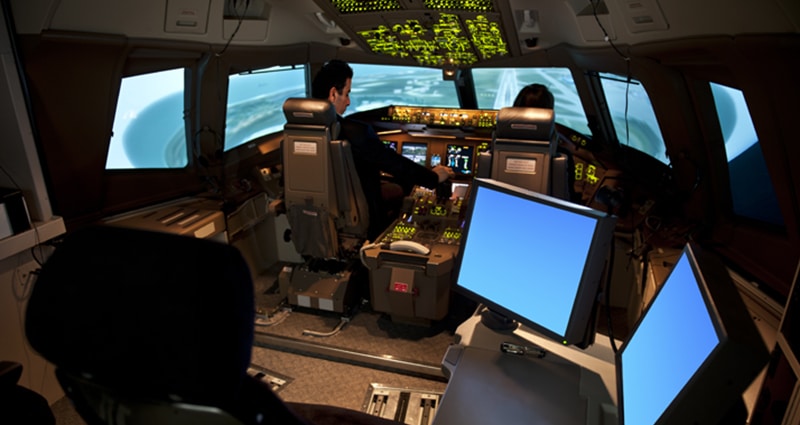 Two pilots in a flight simulator