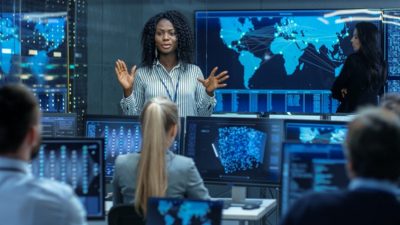 Woman addressing cyber concerns to coworkers