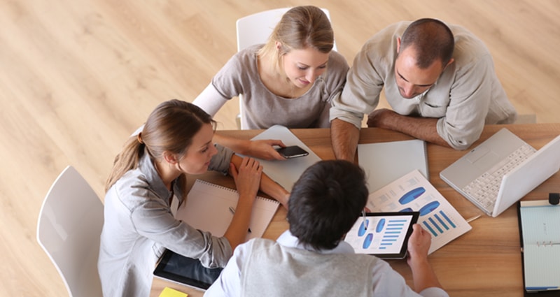 Group of coworkers working at table