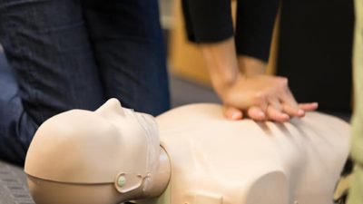 Person administering CPR on dummy