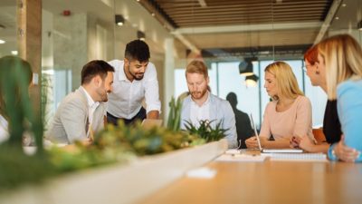 Group of professionals chatting around table