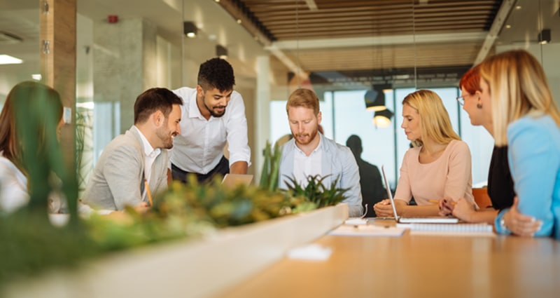 Group of professionals chatting around table