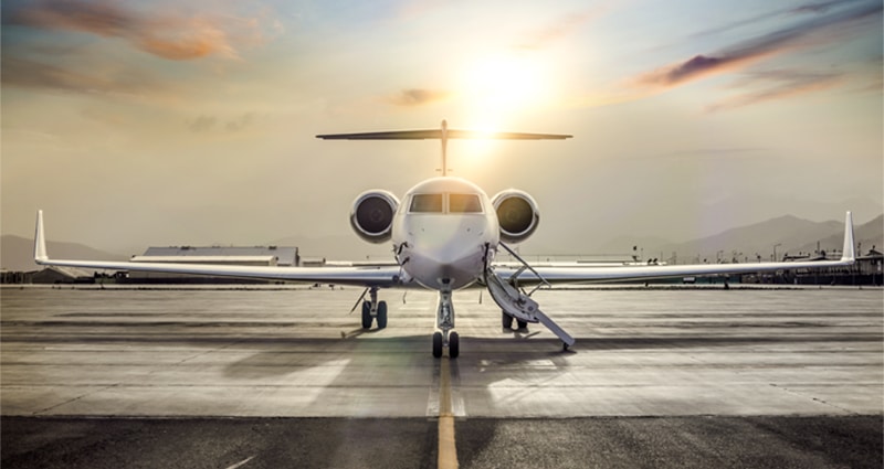 Private jet taxiing at sunset