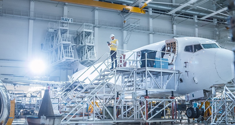 Airplane technician working on large aircraft