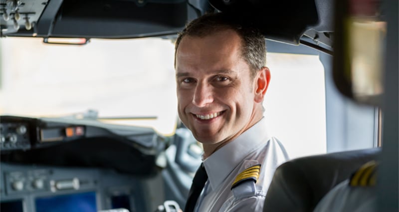 Pilot turned around smiling from cockpit