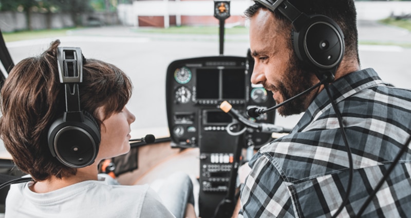 Older pilot teaching younger pilot