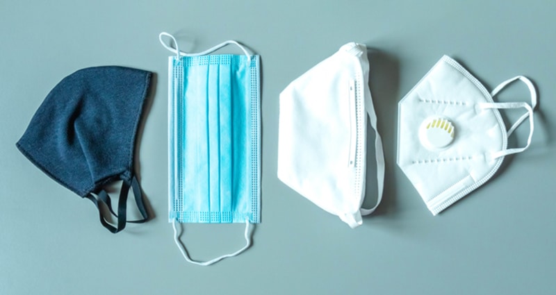 Four different face masks laying on table