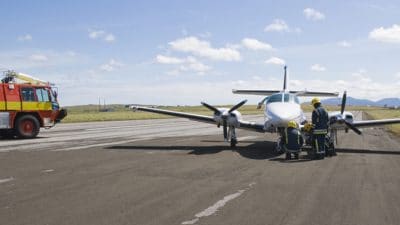 Emergency crew assisting plane on runway