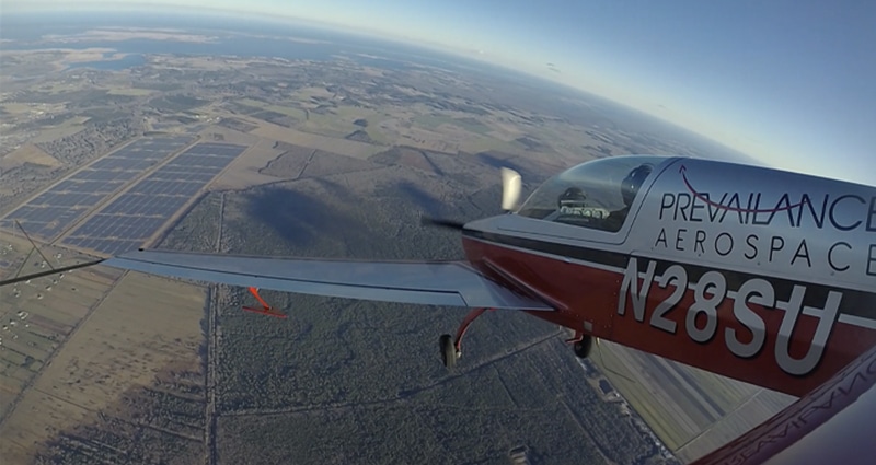 Small plane flying above solar farm