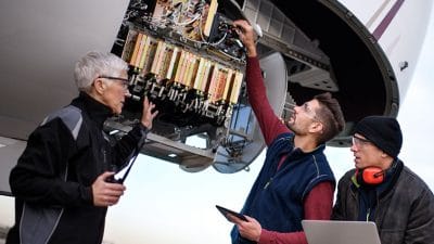 mechanics checking aircraft