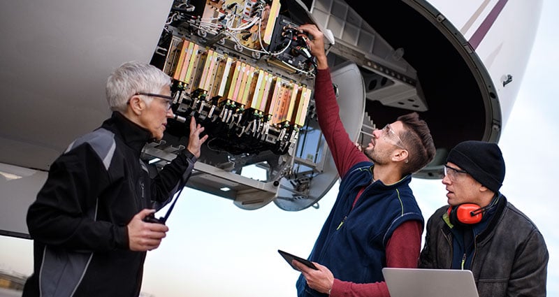 mechanics checking aircraft