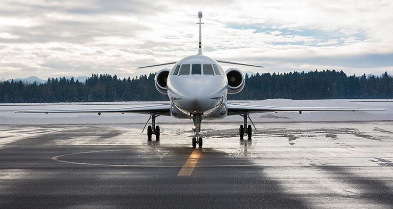 Front view of business jet on runway