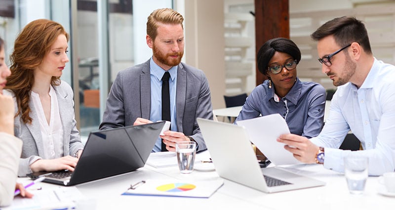 usiness people discussing strategy with a financial analyst