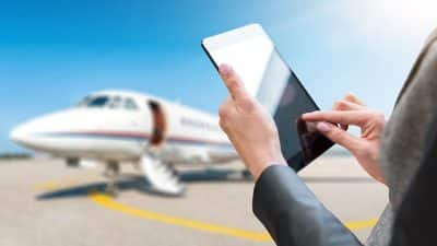 woman holding digital tablet in the airport runway