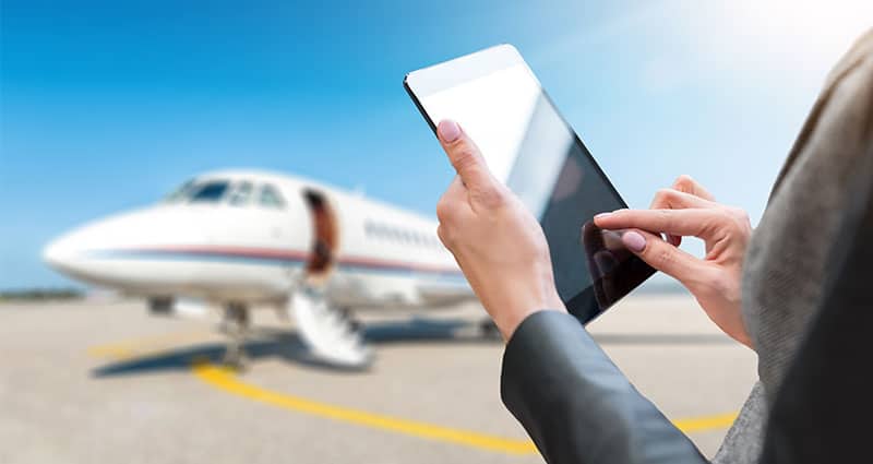 woman holding digital tablet in the airport runway