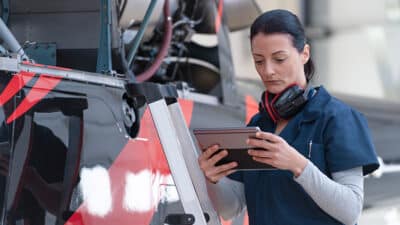 female mechanic review specs on tablet