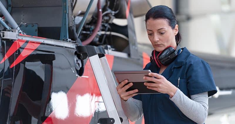 female mechanic review specs on tablet