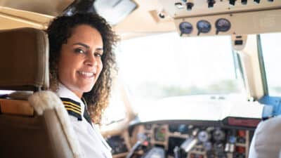 airplane pilot looking over shoulder in a private jet