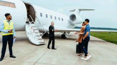 Aircraft crew meeting passengers.