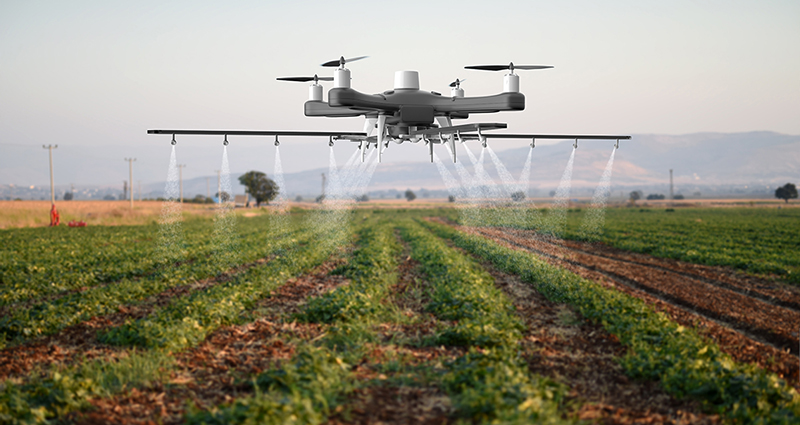 agricultural drone spraying a field