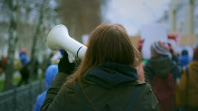 woman with megaphone at demonstration