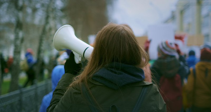 woman with megaphone at demonstration