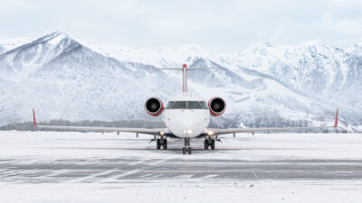 Aircraft on snowy runway in mountains