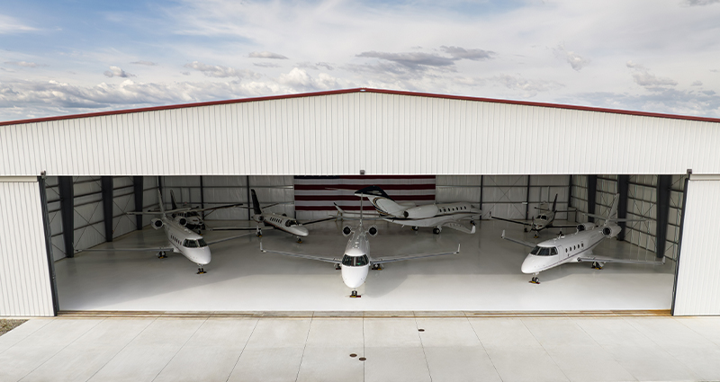 Airplane Hangar With Private Jets Parked Inside