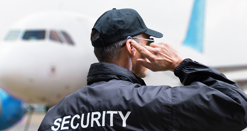 airport security guard listening to earpiece